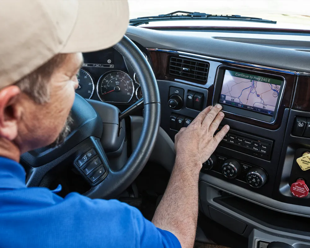 Driver using GPS navigation system in truck