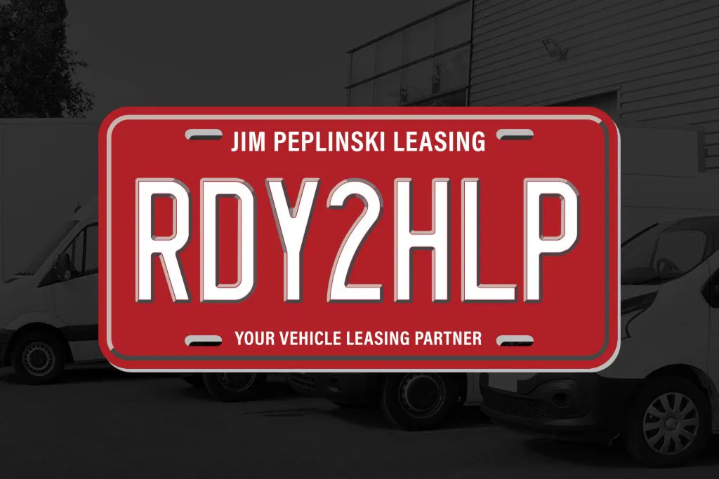 Red license plate advertisement 'RDY2HLP' with company name.